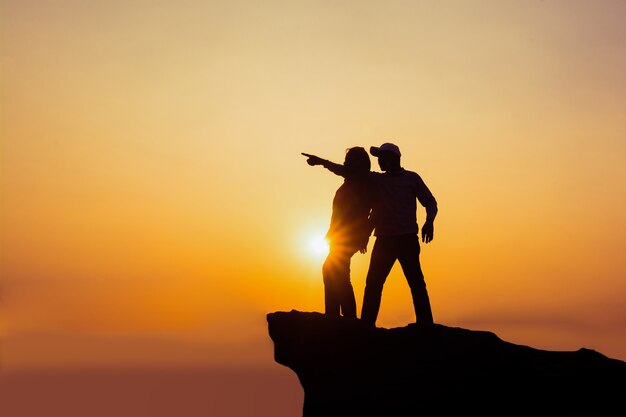 Silhouette young couple at sunset.