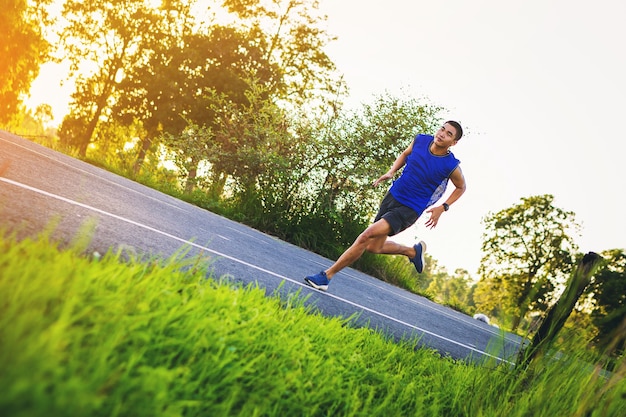 Silhouette of Young man running sprinting on road Fit runner fitness runner during outdoor workout