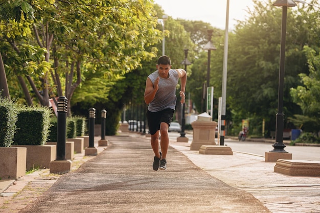 Silhouette of young man running sprinting on road Fit runner fitness runner during outdoor workout