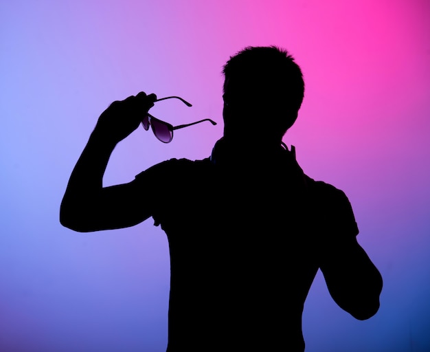 Silhouette of young man with sunglasses 