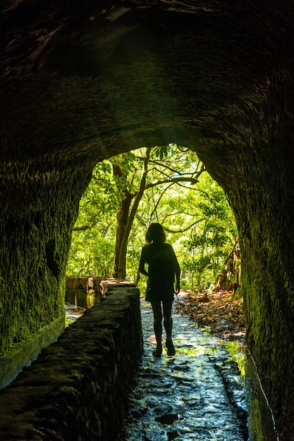 Silhouette of a young woman in the cave at Levada do Caldeirao Verde Queimadas Madeira