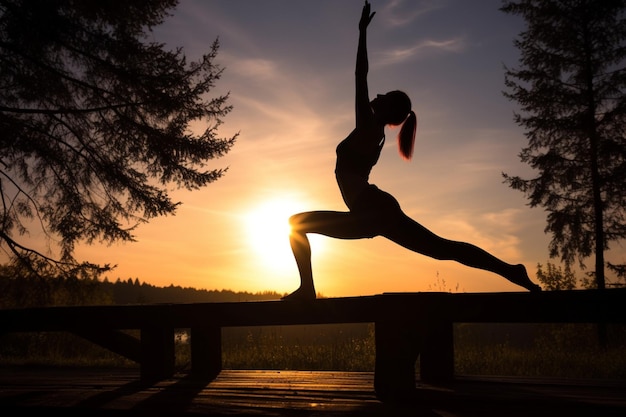 Silhouette of young woman practicing yoga outdoors