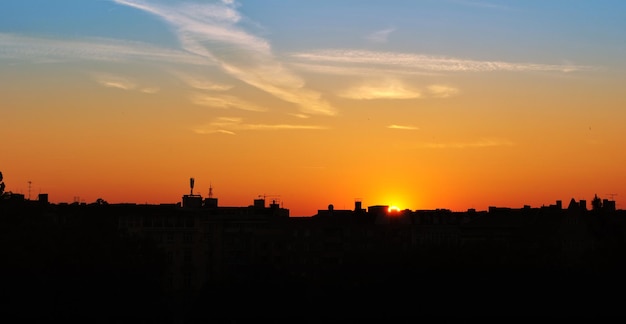 Silhouetten van gebouwen tegen de hemel bij zonsondergang