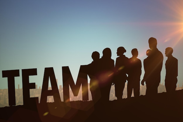 silhouetters celebrating against blue green background