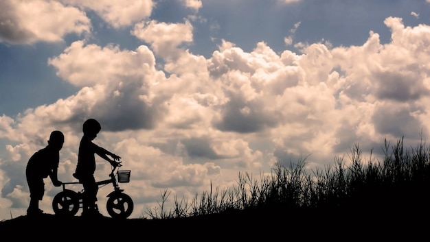 Silhouettes of children playing with friends.