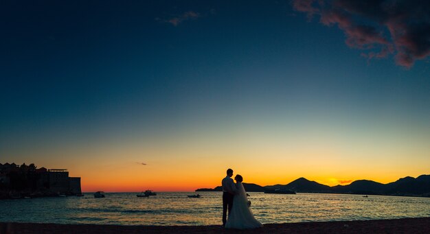 Silhouettes of couples near sveti stefan