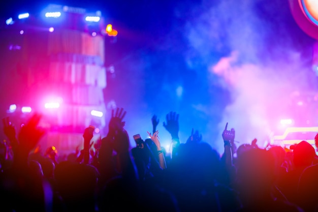 Silhouettes of hand in concert.Light from the stage.