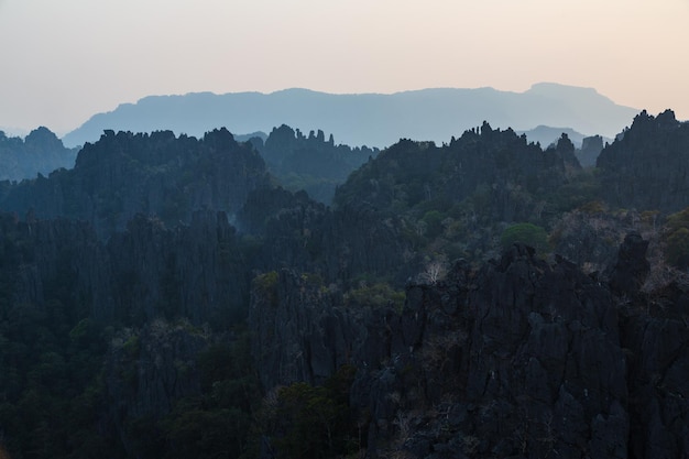 Silhouettes of limestone rocky hills at sunset Laos