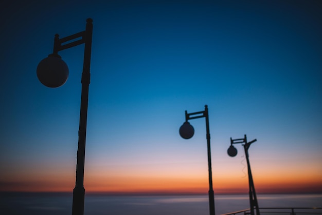 Silhouettes of street lamps at sunset