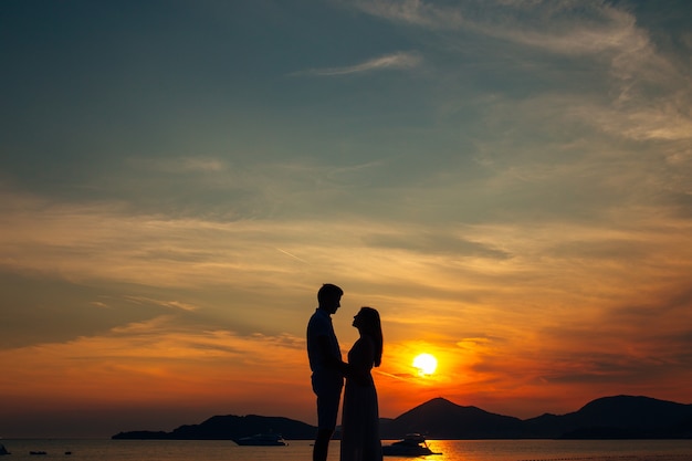 Silhouettes at sunset on the beach in Montenegro