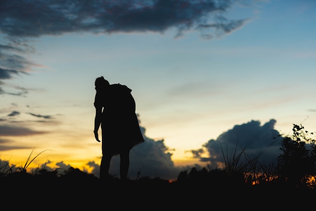 Silhouettes women happily at sunset.