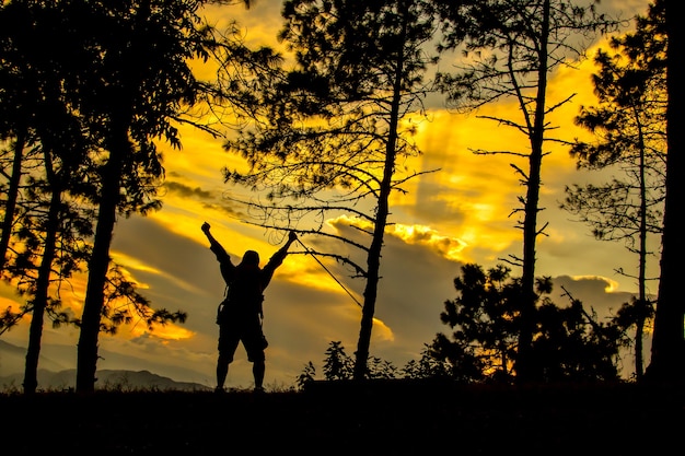 Silhoutte of man climbing and happy at terminal way