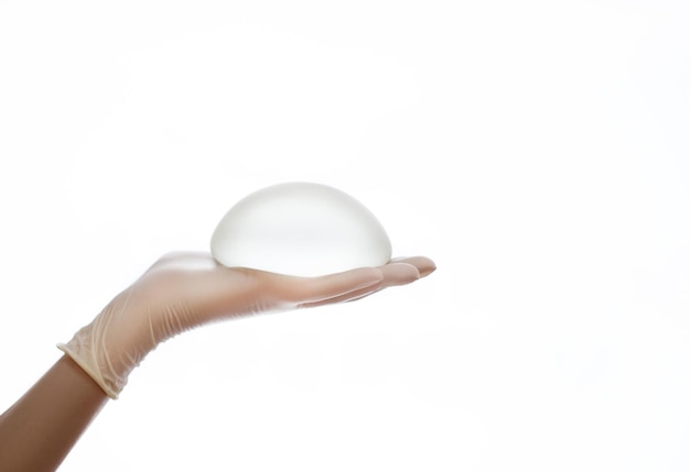 Silicone breast implant on hands