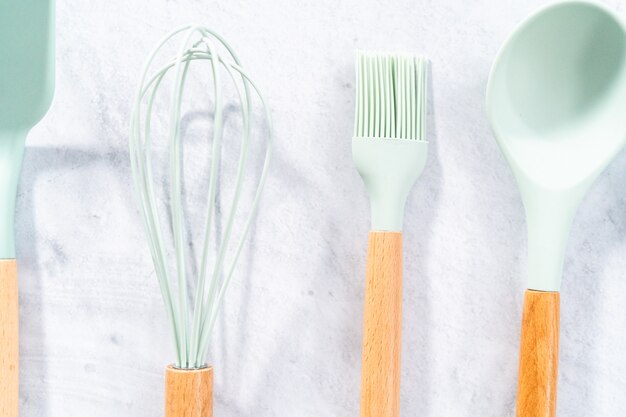 Silicone cooking utensils with wooden handle.