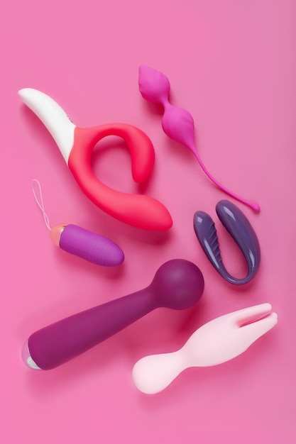 Silicone sex toys on a pink background. Erotic toy for fun. Sex gadget and masturbation device.