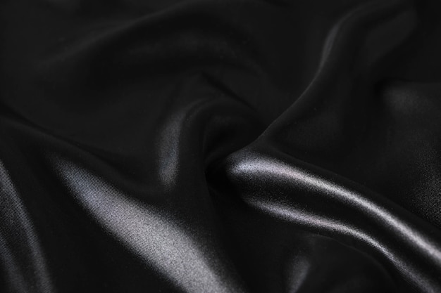 Silk fabric abstract wavy black satin fabric background