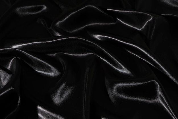 Silk fabric abstract wavy black satin fabric background