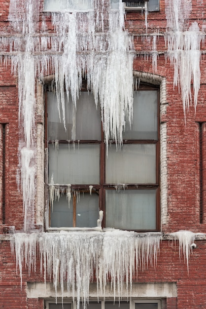 The sill is covered with large icicles from the window