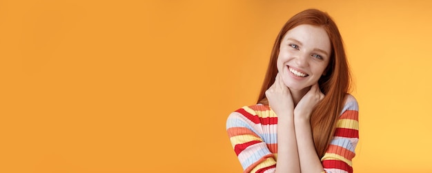 Silly enthusiastic attractive redhead blueeyed girl tilting head touching neck flirty smiling enjoy