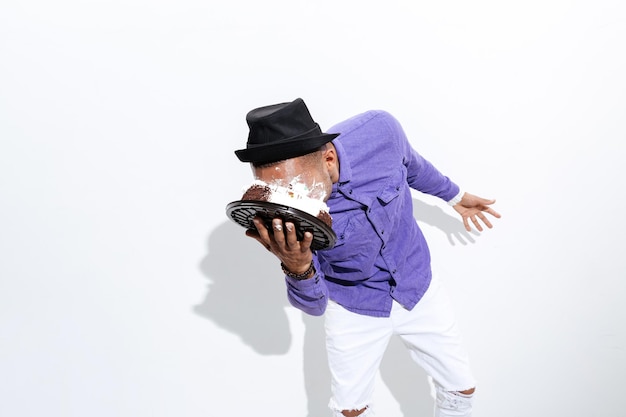 Silly man has pie all over his face isolated on the white background