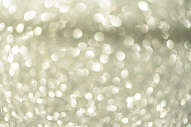 Silver abstract bokeh lights. Defocused background with copy space. 