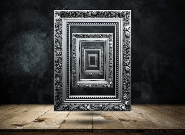 Silver Antique picture Frame on dark grunge wall with Wooden table top mysterious, confused, background 