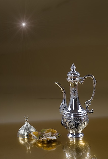 silver arabic teapot on gold background