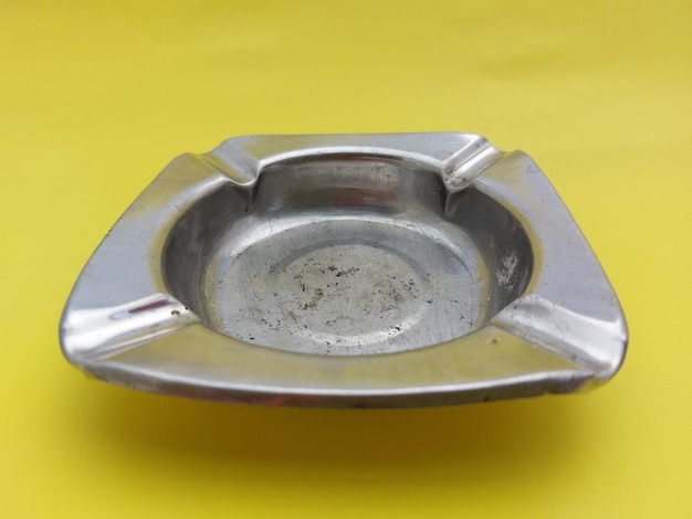 Silver ashtray Isolated on yellow background