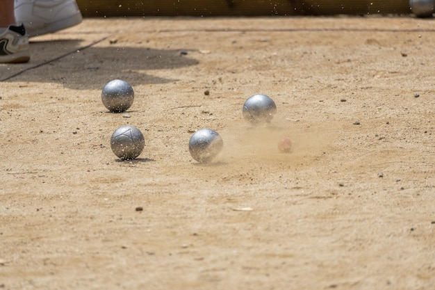 Silver balls are on the ground and the ball is flying in the air.