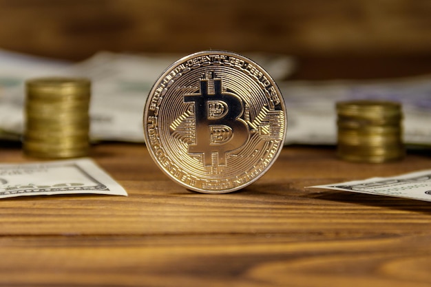 Silver bitcoin and dollars on wooden background