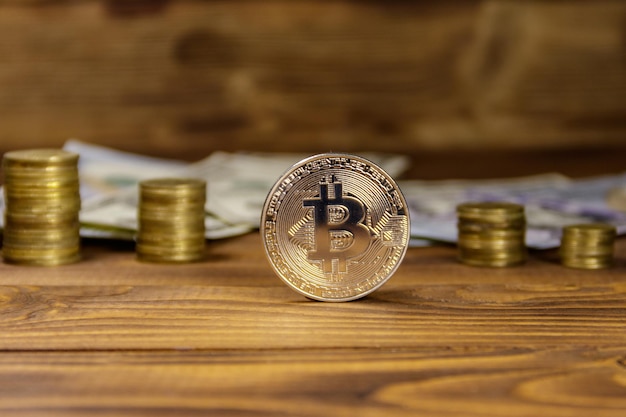 Silver bitcoin and dollars on wooden background