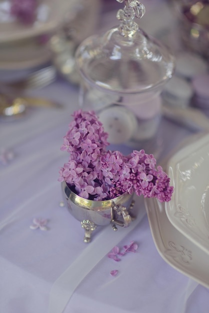 A silver bowl with purple flowers on it