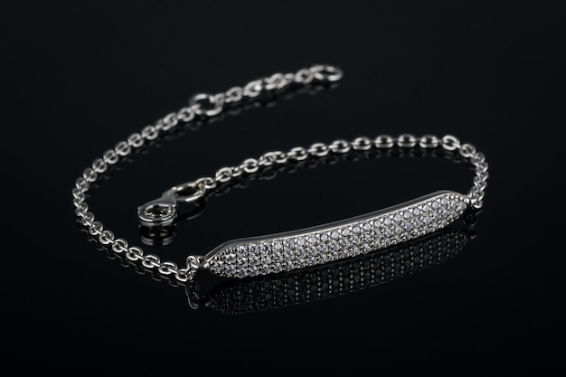 Silver bracelet with diamonds on black background