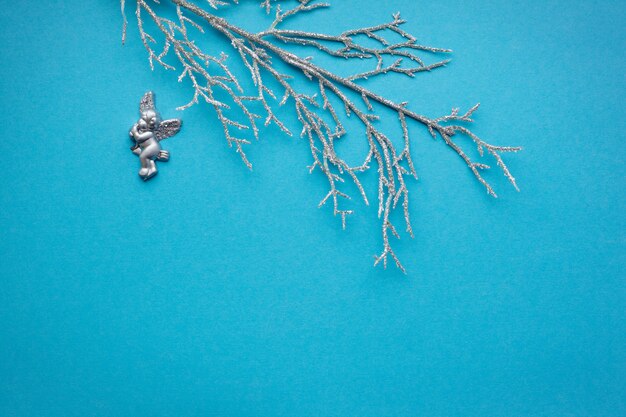 Silver branch with an angel on a blue background