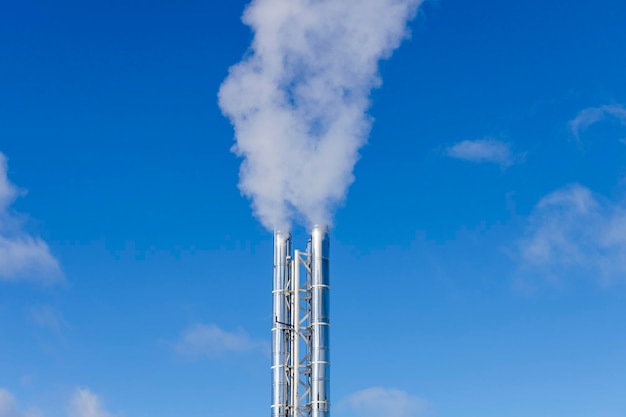 Silver chimneys with smoke. working boiler room. Pollution. High quality photo