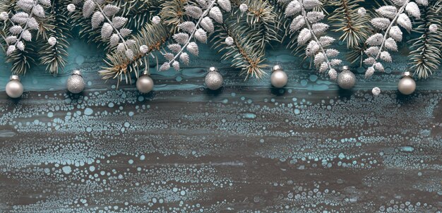 Silver christmas border with fir twigs glass baubles and exotic fern leaves copyspace place for