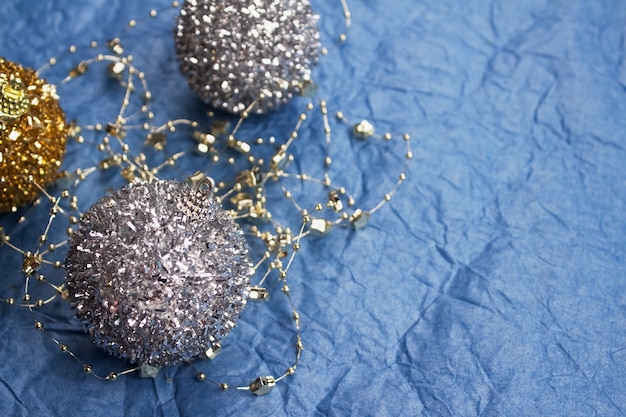 Silver christmas tree balls on blue table