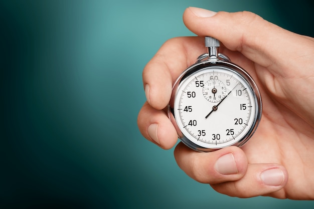 Photo silver classic stopwatch in human hand