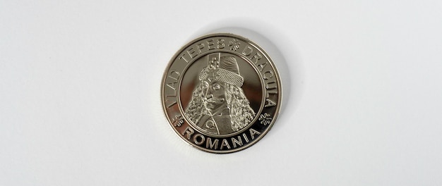 A silver coin with a man in a pirate hat on it.