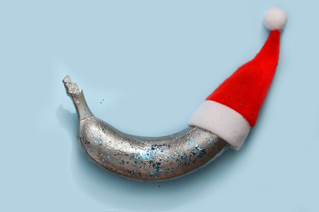 Silver colored banana in a New Year hat 