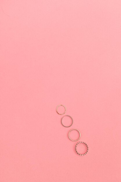 Photo silver costume jewelry on a delicate pink background advertising shoot