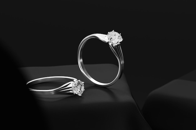 Silver Couple Diamond rings on Black background 3d rendering Soft focus