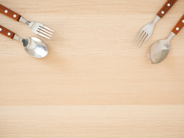 Silver cutlery set on wooden table