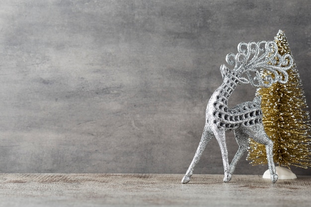 Silver deer on gray background. Christmas background.