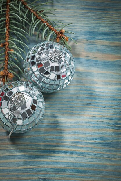 Silver disco baubles green fir brunch on wooden board celebrations concept