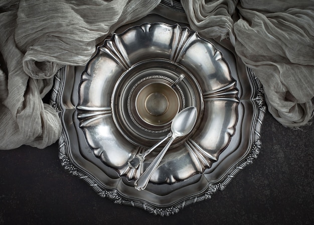 Silver dishes on old surface