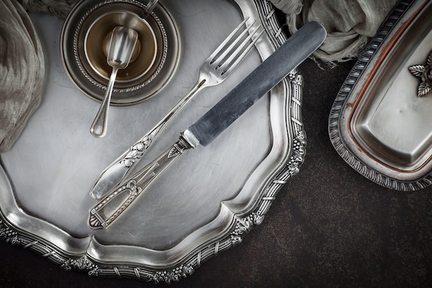 Silver dishes on old table