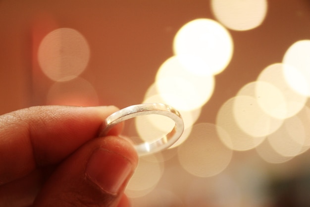 Silver engagement ring on woman finger