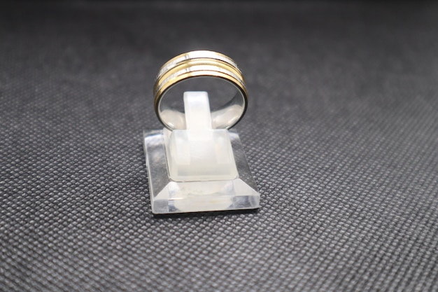 a silver and gold ring on shelf