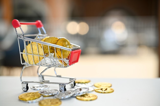 Silver and golden bitcoins in shopping cart on the table shopping financial concept